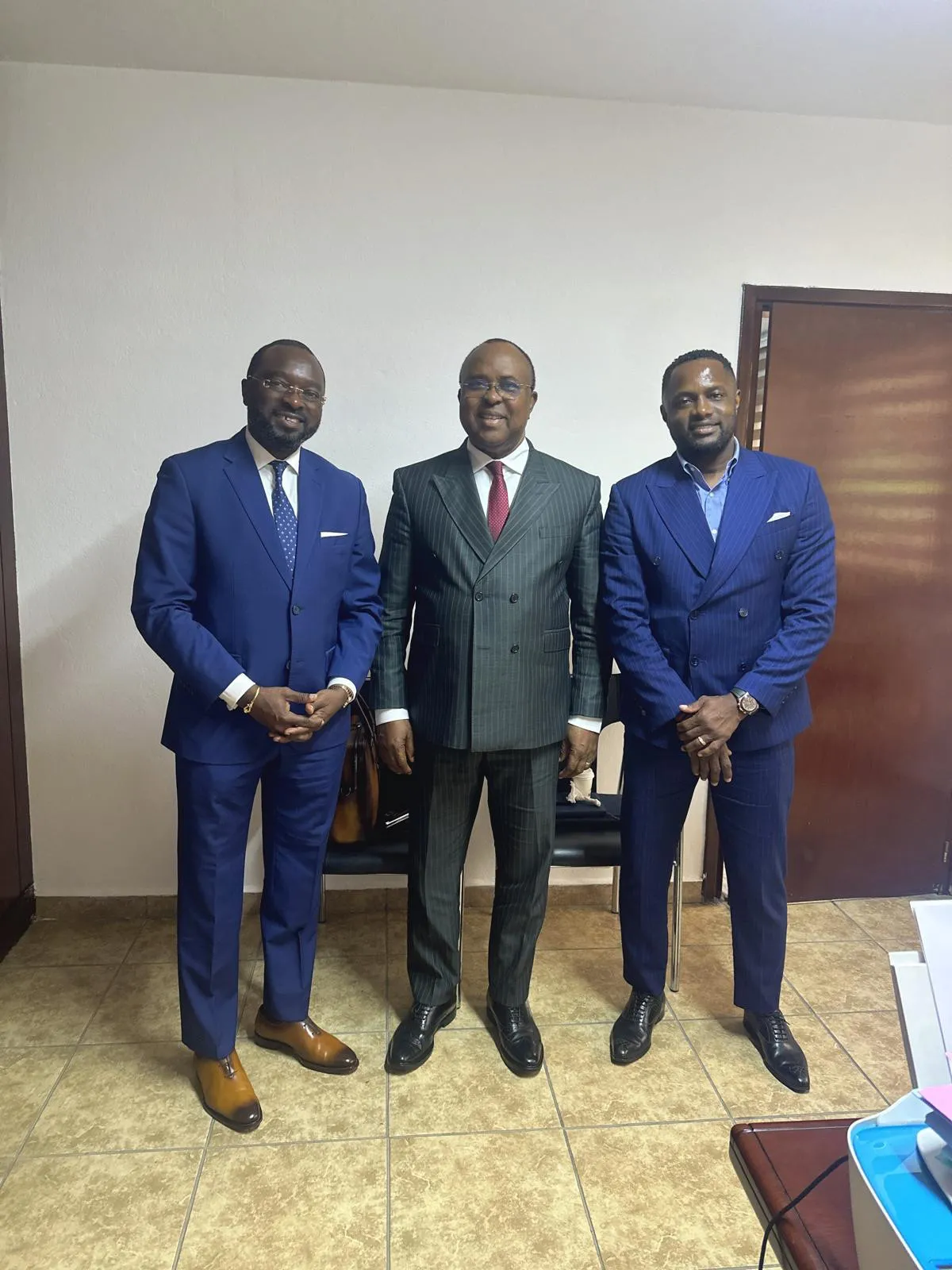 Three African business principals in tailored suits — counterparties and partners on the continent.