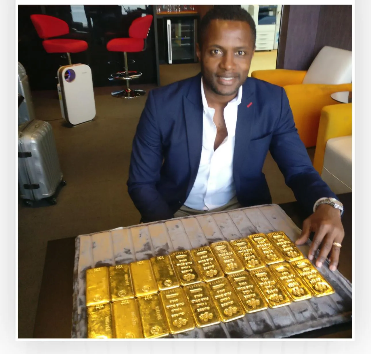 Loyal Shield team with a desk display of stacked gold bullion bars.