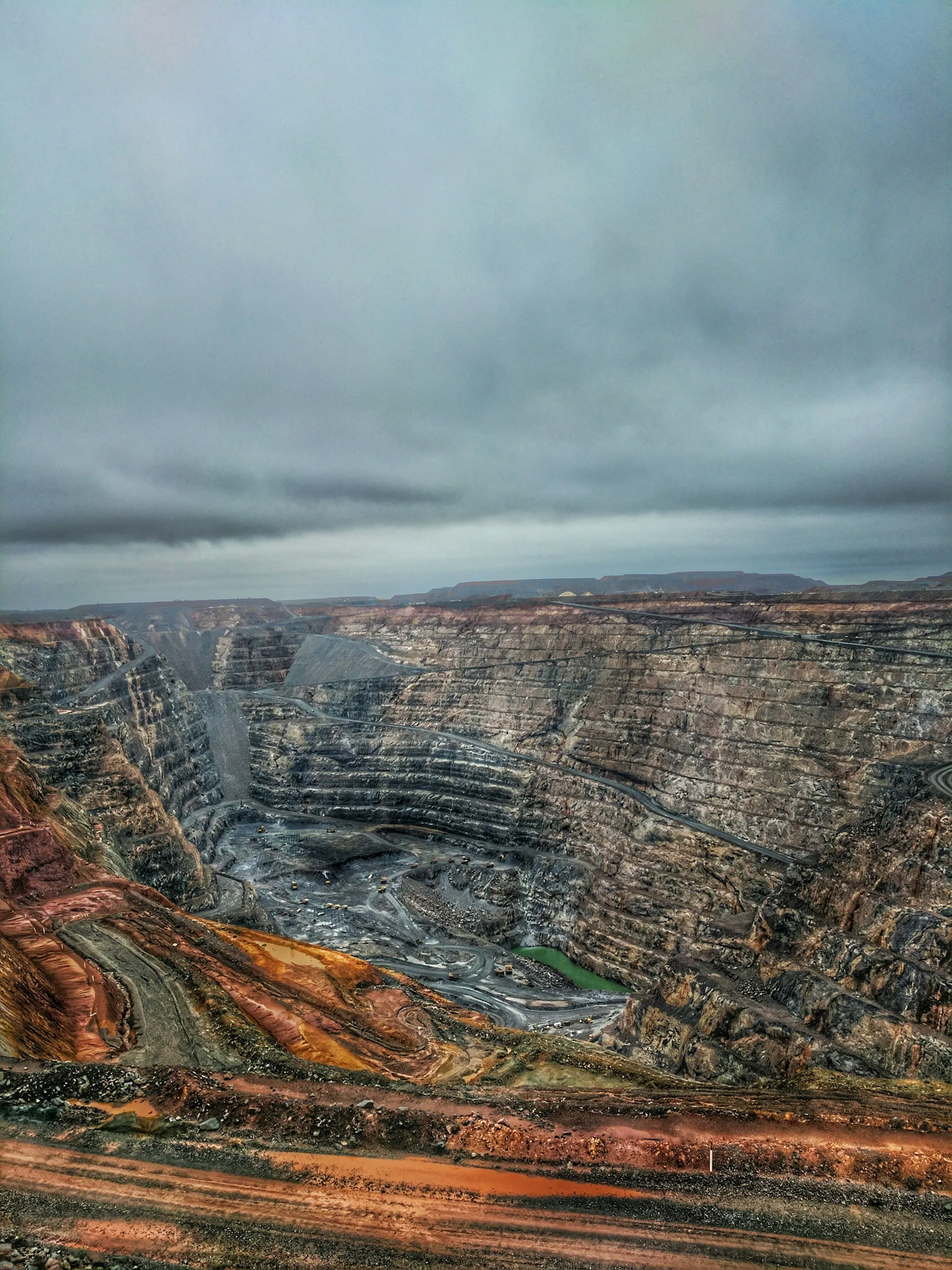 Aerial view of a wide open-pit mining operation.